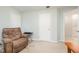 Cozy bedroom with recliner, side table, and access to the bathroom, perfect for relaxation at 302 Caraway Ln, Cary, NC 27519