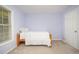 Bright bedroom featuring a twin bed, white bedding and ample natural light from a window at 302 Caraway Ln, Cary, NC 27519