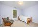 Comfortable bedroom with a twin bed, rocking chair and a window bringing in natural light at 302 Caraway Ln, Cary, NC 27519