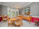 Bright dining room with a wooden table, side cabinets, and large windows for natural light at 302 Caraway Ln, Cary, NC 27519