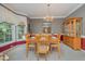 Elegant dining room with a chandelier, ample seating, and a view of the outdoor scenery at 302 Caraway Ln, Cary, NC 27519