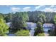 Charming two-story home with a welcoming front porch, set amidst lush greenery and mature trees at 302 Caraway Ln, Cary, NC 27519