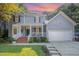 Charming two-story home with a two-car garage, light gray siding, and a lovely front porch at 302 Caraway Ln, Cary, NC 27519