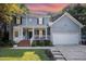 Charming two-story home with a two-car garage, light gray siding, and a lovely front porch at 302 Caraway Ln, Cary, NC 27519