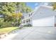 Charming two-story home with a two-car garage, light gray siding, and a long driveway at 302 Caraway Ln, Cary, NC 27519