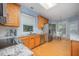 Well-lit kitchen featuring stainless steel appliances, wood cabinets, and granite countertops at 302 Caraway Ln, Cary, NC 27519