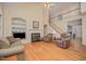 Living room featuring a fireplace, hardwood floors, and vaulted ceiling at 302 Caraway Ln, Cary, NC 27519