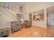 Open living space with hardwood floors flowing to kitchen and staircase at 302 Caraway Ln, Cary, NC 27519