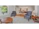 Open-concept living room with comfortable armchairs leading into the dining area and front door at 302 Caraway Ln, Cary, NC 27519