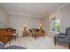 Comfortable living room with traditional furnishings, including a sofa, armchairs, and a piano at 302 Caraway Ln, Cary, NC 27519