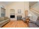 Inviting living room with a fireplace, hardwood floors, and staircase at 302 Caraway Ln, Cary, NC 27519