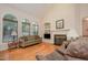 Bright living room featuring hardwood floors, large windows, and a fireplace at 302 Caraway Ln, Cary, NC 27519