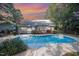 Backyard pool featuring a spacious deck, well-maintained landscaping, and a charming home exterior at 302 Caraway Ln, Cary, NC 27519