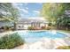 Backyard pool featuring a spacious deck, well-maintained landscaping, and a charming home exterior at 302 Caraway Ln, Cary, NC 27519