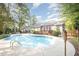 Backyard pool featuring a spacious deck, outdoor decor, well-maintained landscaping, and a charming home exterior at 302 Caraway Ln, Cary, NC 27519