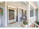 Welcoming front porch with a dark front door, a 'welcome' sign, and cozy seating at 302 Caraway Ln, Cary, NC 27519