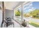 Inviting front porch with wicker chairs and potted plants, perfect for relaxing outdoors at 302 Caraway Ln, Cary, NC 27519