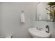 Well-lit powder room featuring a sink, mirror, and modern fixtures at 302 Caraway Ln, Cary, NC 27519