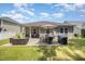 An exterior of the house showing the covered porch and outdoor patio with grill at 3037 Willow Ranch Dr, Fuquay Varina, NC 27526