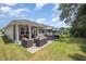 View of the backyard with patio seating, landscaped greenery, and the home's siding at 3037 Willow Ranch Dr, Fuquay Varina, NC 27526
