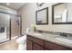 Bathroom offers a glass-enclosed shower, granite counters, and double sink vanity at 3037 Willow Ranch Dr, Fuquay Varina, NC 27526