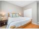 Comfortable bedroom featuring a bed with decorative pillows, wood floors, and side tables at 3037 Willow Ranch Dr, Fuquay Varina, NC 27526