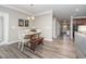 Light-filled dining area features wood-look flooring, a modern light fixture, and neutral wall paint at 3037 Willow Ranch Dr, Fuquay Varina, NC 27526
