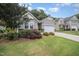 Attractive single-story home with a landscaped front yard and a two-car garage at 3037 Willow Ranch Dr, Fuquay Varina, NC 27526