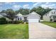 Charming single-story home with a well-manicured lawn and a two-car garage at 3037 Willow Ranch Dr, Fuquay Varina, NC 27526
