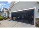 View of the open garage featuring a screen door with a parked motorcycle inside at 3037 Willow Ranch Dr, Fuquay Varina, NC 27526