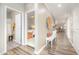 Bright hallway featuring wood floors leading to a bathroom, bedroom, and living room at 3037 Willow Ranch Dr, Fuquay Varina, NC 27526