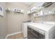 Functional laundry room with washer, dryer, and wire shelving for storage at 3037 Willow Ranch Dr, Fuquay Varina, NC 27526