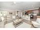Open-concept living room with views of the kitchen, featuring modern furniture and natural light at 3037 Willow Ranch Dr, Fuquay Varina, NC 27526