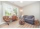 Cozy living room featuring ample natural light, wood floors and comfortable furnishings at 3037 Willow Ranch Dr, Fuquay Varina, NC 27526