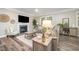 Cozy living room featuring a fireplace, modern furniture, and a large window providing ample natural light at 3037 Willow Ranch Dr, Fuquay Varina, NC 27526