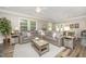 Spacious living room with stylish furniture, including a large sofa, and ample natural light at 3037 Willow Ranch Dr, Fuquay Varina, NC 27526