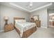 Bright main bedroom features a tray ceiling, fan, carpet, and classic wood furnishings at 3037 Willow Ranch Dr, Fuquay Varina, NC 27526