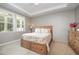 Comfortable main bedroom boasts plush carpeting, a tray ceiling with fan, and natural light at 3037 Willow Ranch Dr, Fuquay Varina, NC 27526