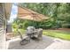 A view of the outdoor dining area with an umbrella in the backyard of the house at 3037 Willow Ranch Dr, Fuquay Varina, NC 27526