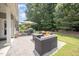 A stone patio features comfortable outdoor seating, dining set, and lush green landscaping at 3037 Willow Ranch Dr, Fuquay Varina, NC 27526