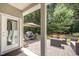 Relaxing covered patio with a stone floor, dining set, and cozy seating area at 3037 Willow Ranch Dr, Fuquay Varina, NC 27526