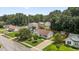 Aerial view of a home with manicured lawn, mature trees, and proximity to other homes in a suburban setting at 304 Quailwood Dr, Fuquay Varina, NC 27526