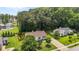 Aerial view of a home with a fenced backyard, mature trees, and a well-maintained lawn in a quiet neighborhood at 304 Quailwood Dr, Fuquay Varina, NC 27526