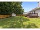 Expansive backyard with a wooden fence, storage shed, and deck, perfect for outdoor activities at 304 Quailwood Dr, Fuquay Varina, NC 27526