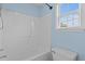 The bathroom features a full shower and tub, with neutral-colored tile, lighting, and a white sink at 304 Quailwood Dr, Fuquay Varina, NC 27526