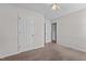 A bedroom with carpet, a ceiling fan, and 2 doors at 304 Quailwood Dr, Fuquay Varina, NC 27526
