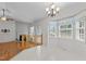 Inviting dining area with natural light, view of living room and modern light fixture at 304 Quailwood Dr, Fuquay Varina, NC 27526