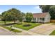 Inviting single-story home with a spacious driveway and a beautifully landscaped front yard at 304 Quailwood Dr, Fuquay Varina, NC 27526