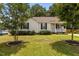 Well-maintained home with a green lawn, mature trees, and a welcoming front porch at 304 Quailwood Dr, Fuquay Varina, NC 27526