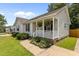 Charming home featuring a cozy front porch, mature landscaping and a neatly manicured lawn at 304 Quailwood Dr, Fuquay Varina, NC 27526